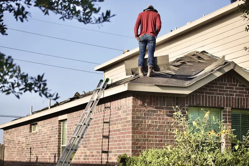 Professional roofer working on a residential roof in La Follette
